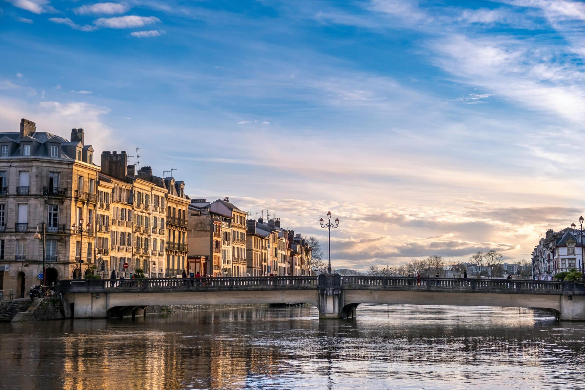 Beautiful view of a bridge over the river in Bayonne, Nouvelle-Aquitaine during sunset.