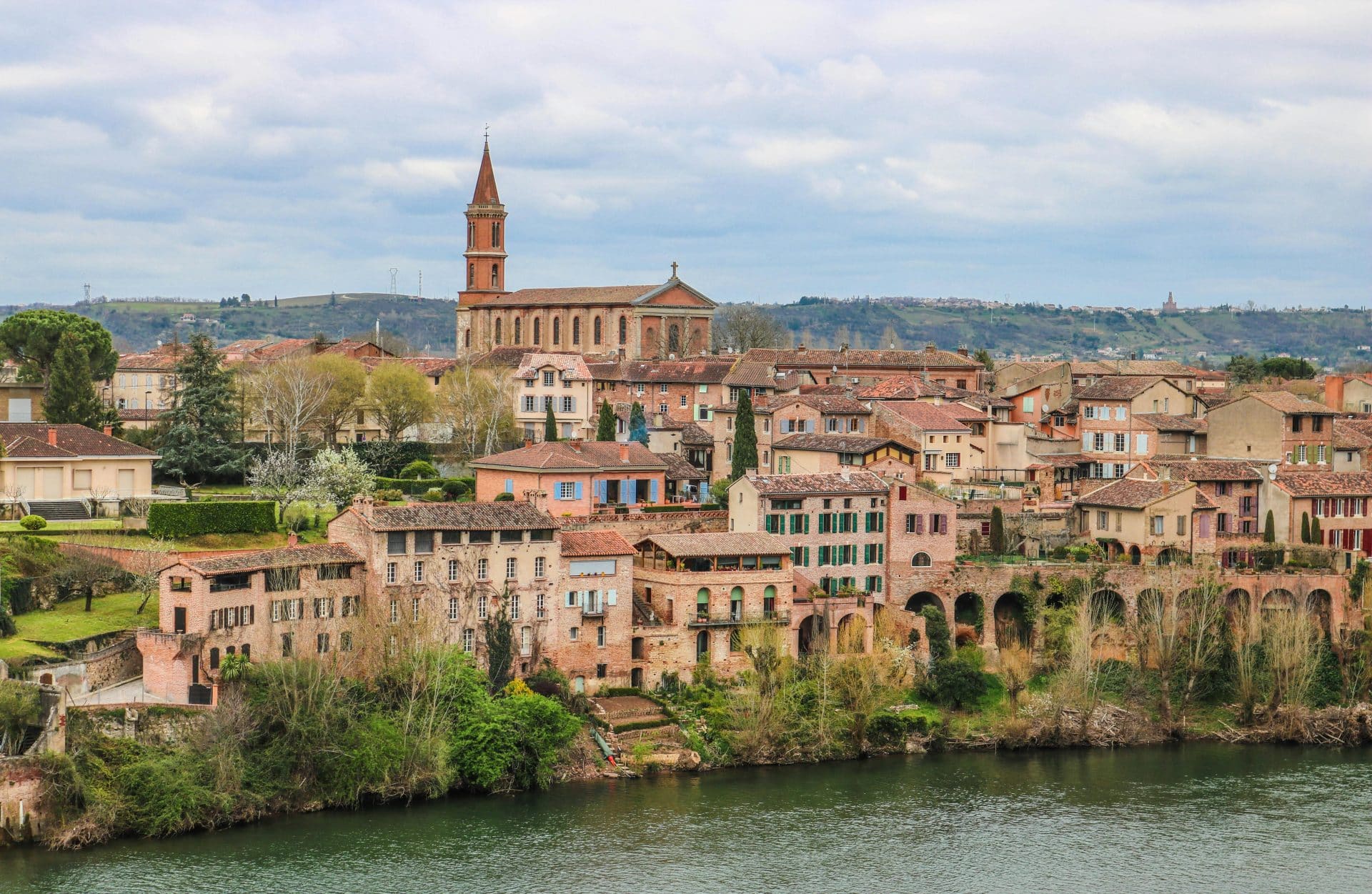 Picturesque view of Albi's historic skyline and River Tarn with classic architecture and landmarks.